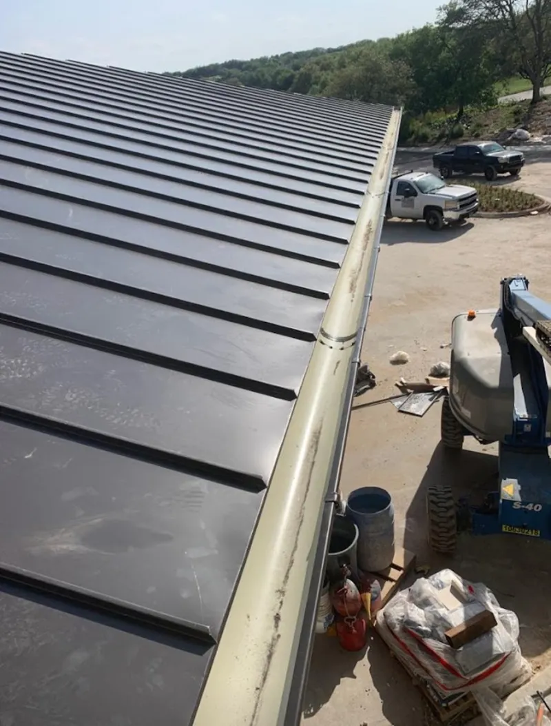 Standing seam panel and gutter detail on a metal roofing jobsite in Bostonia